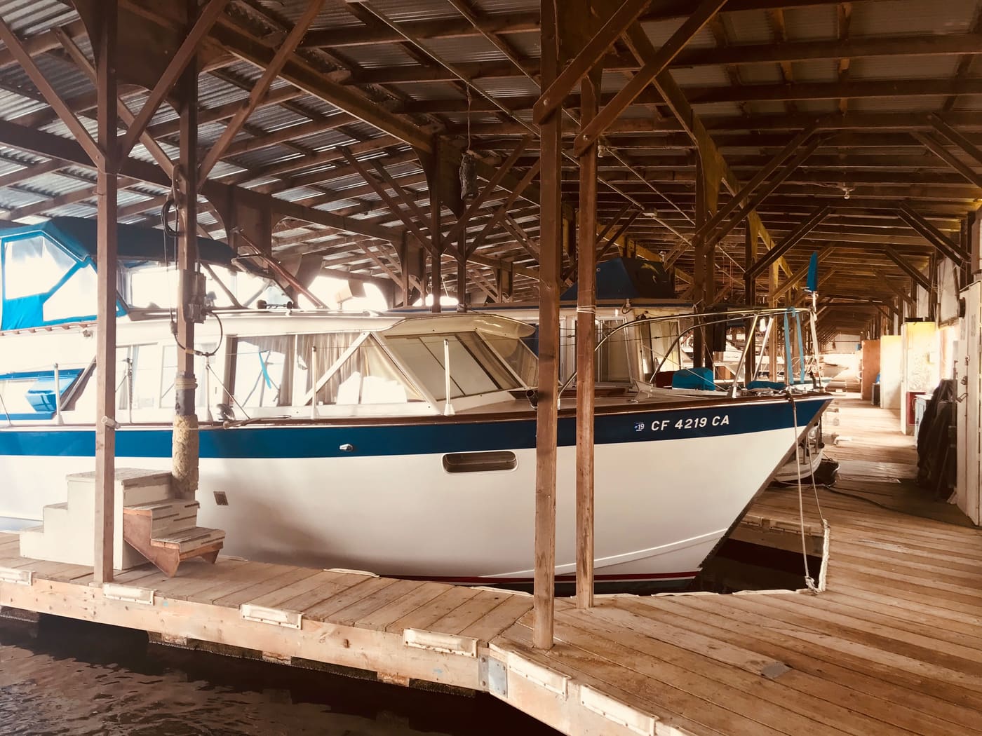 A boat berthed under the timber-framed covered docks